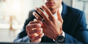 A man is removing his wedding ring, representing gray divorce among older couples facing complex property and retirement division issues.